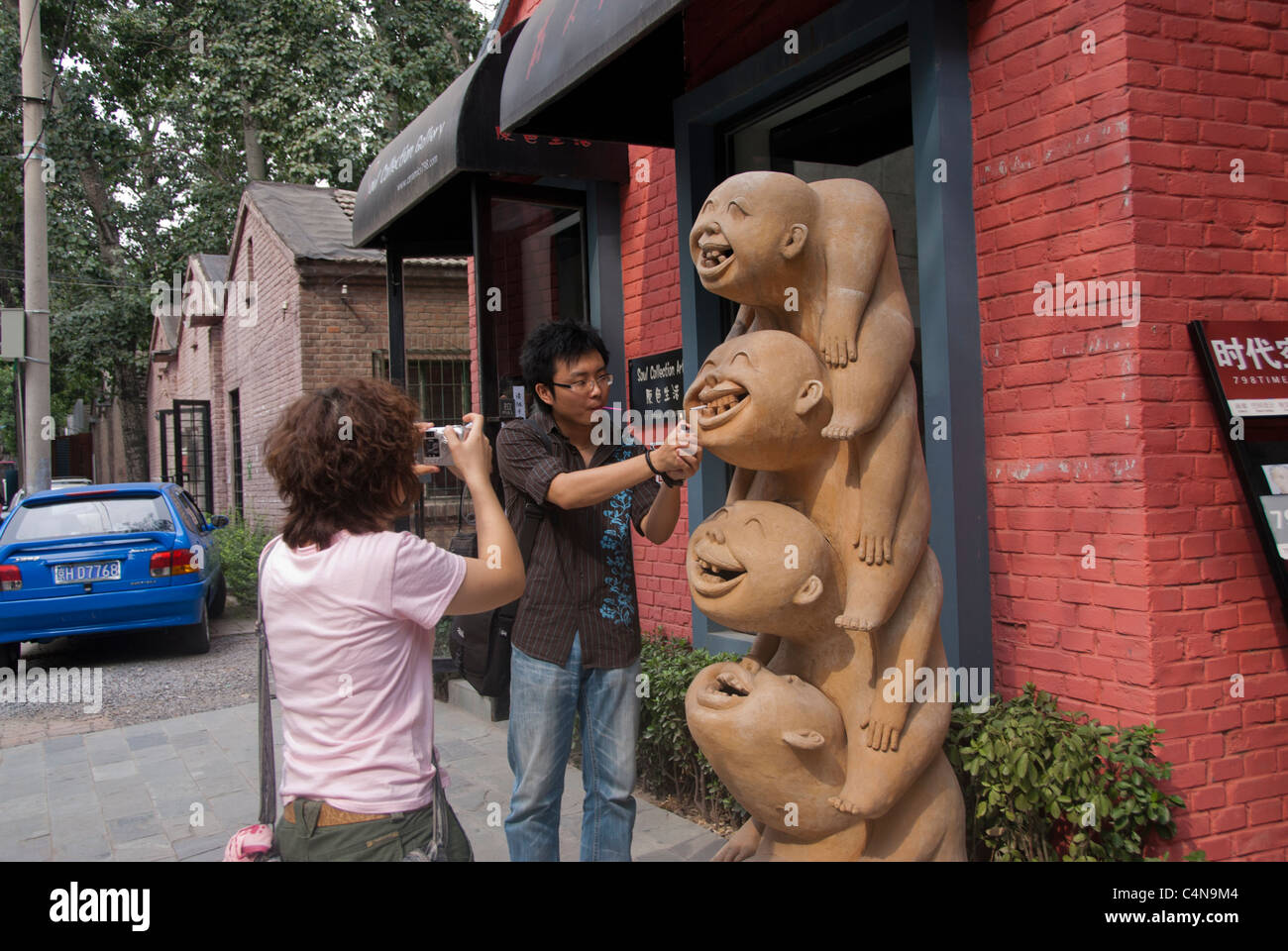 Beijing, China, Modern Chinese Art Gallery Building, Couple Looking at Modern Sculpture in 798 Dashanzi Art District. Stock Photo