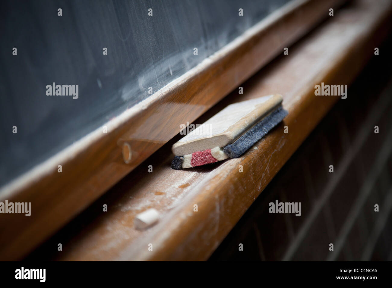 Chalk brush and chalk on blackboard ledge Stock Photo Alamy