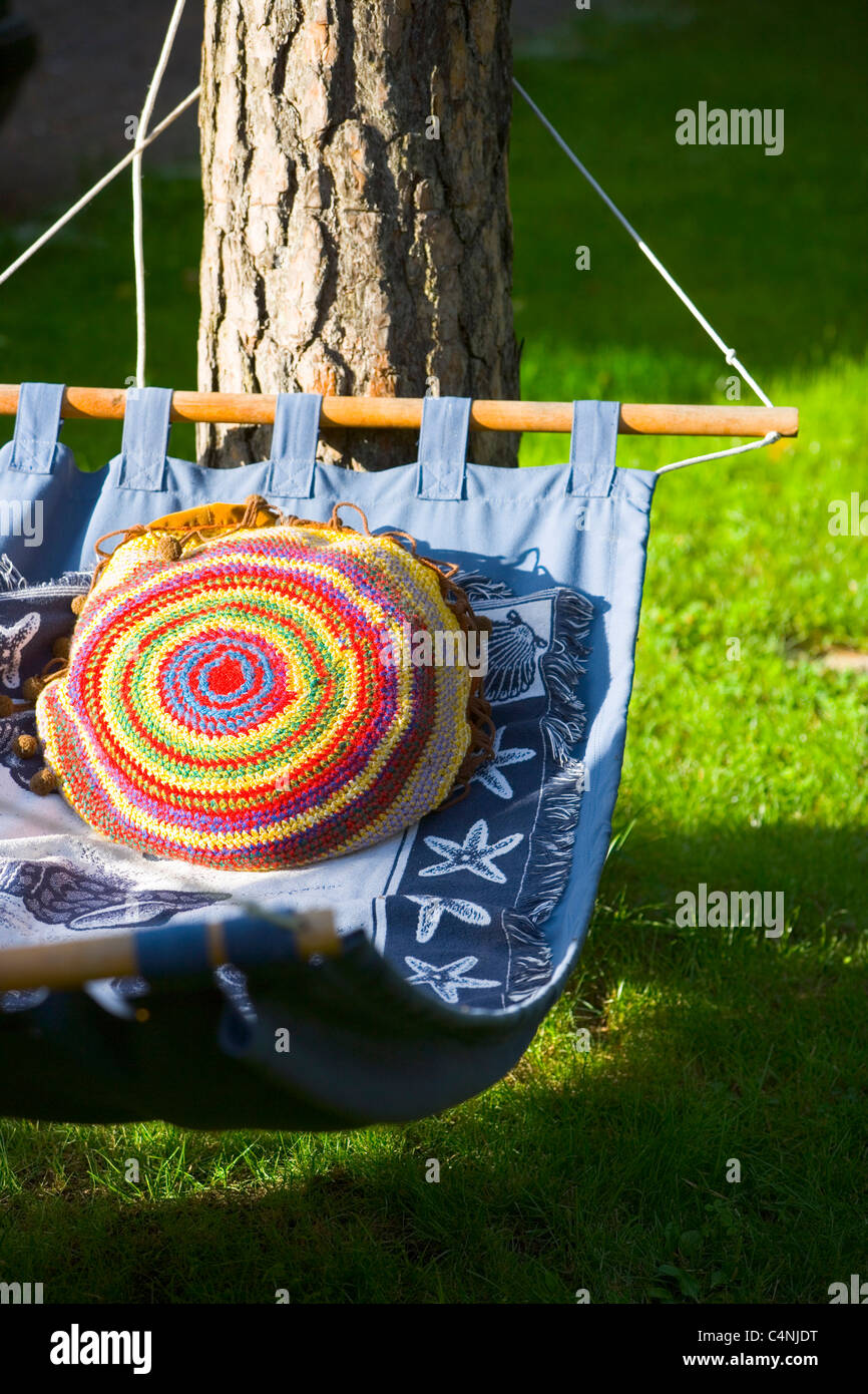 Hammock with a colorful pillow in a garden Stock Photo Alamy