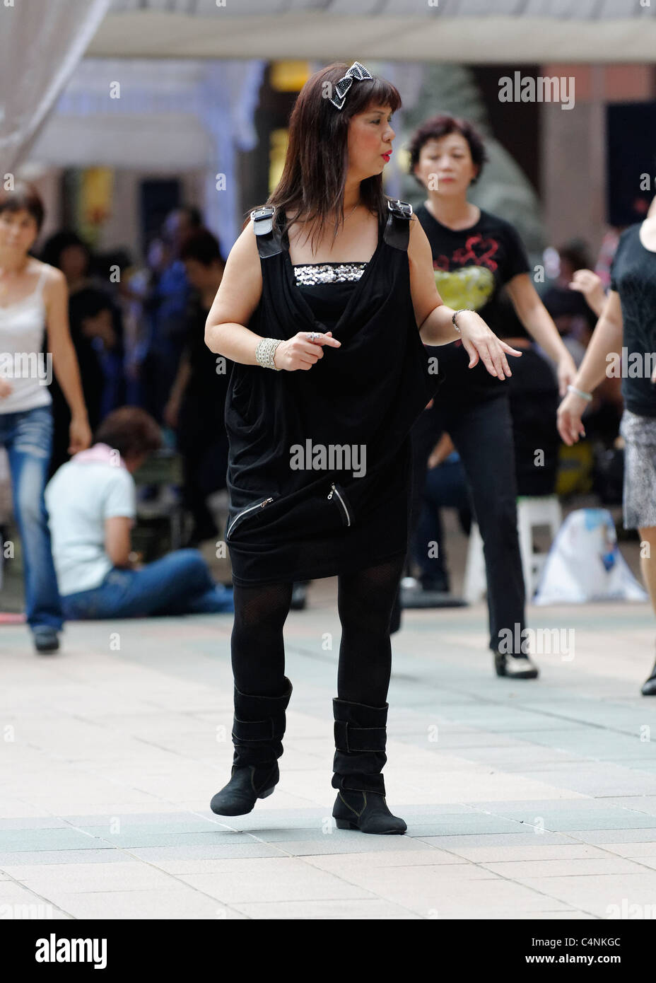 Line dancing woman in Singapore, at a competition on Orchard Road Stock Photo