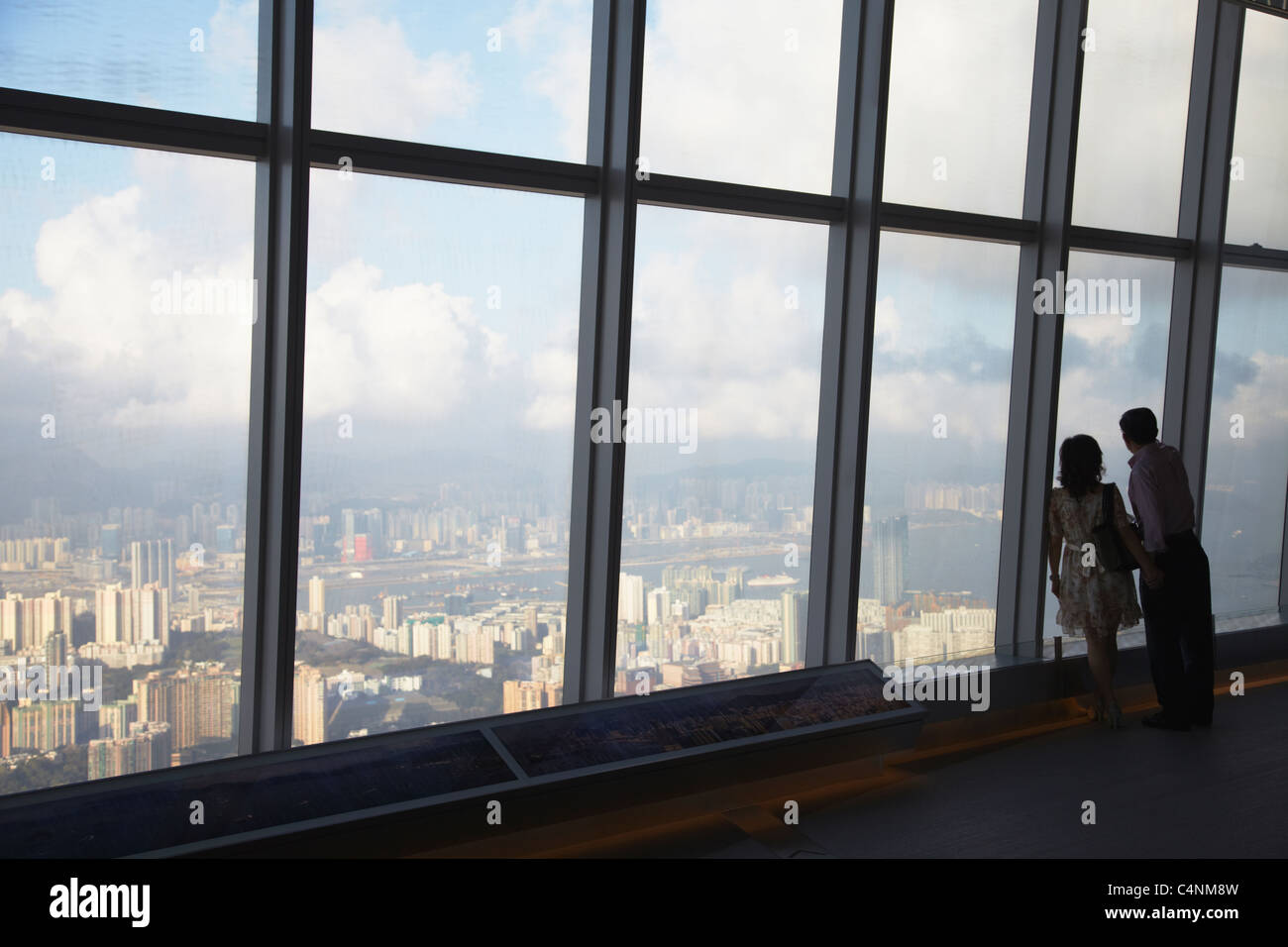 Couple at Sky 100 observation deck in ICC (International Commerce Centre), West Kowloon, Hong Kong, China Stock Photo
