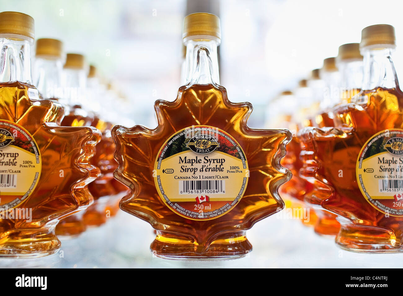Maple Syrup bottles on glass shelves.  Banff, Alberta, Canada. Stock Photo