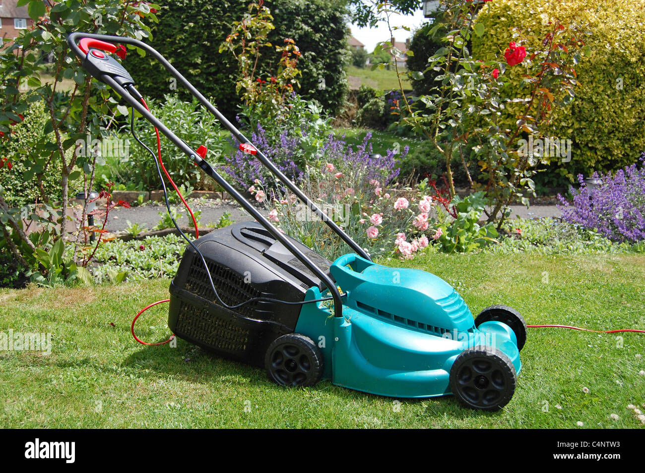 lawnmower in English summer garden Stock Photo