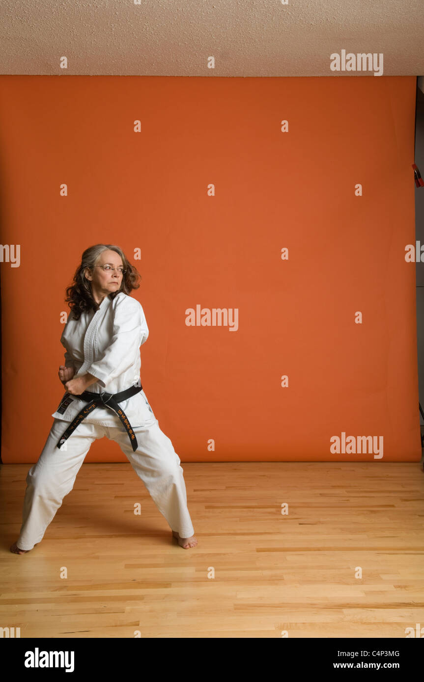 Middleaged woman in karate uniform Stock Photo Alamy