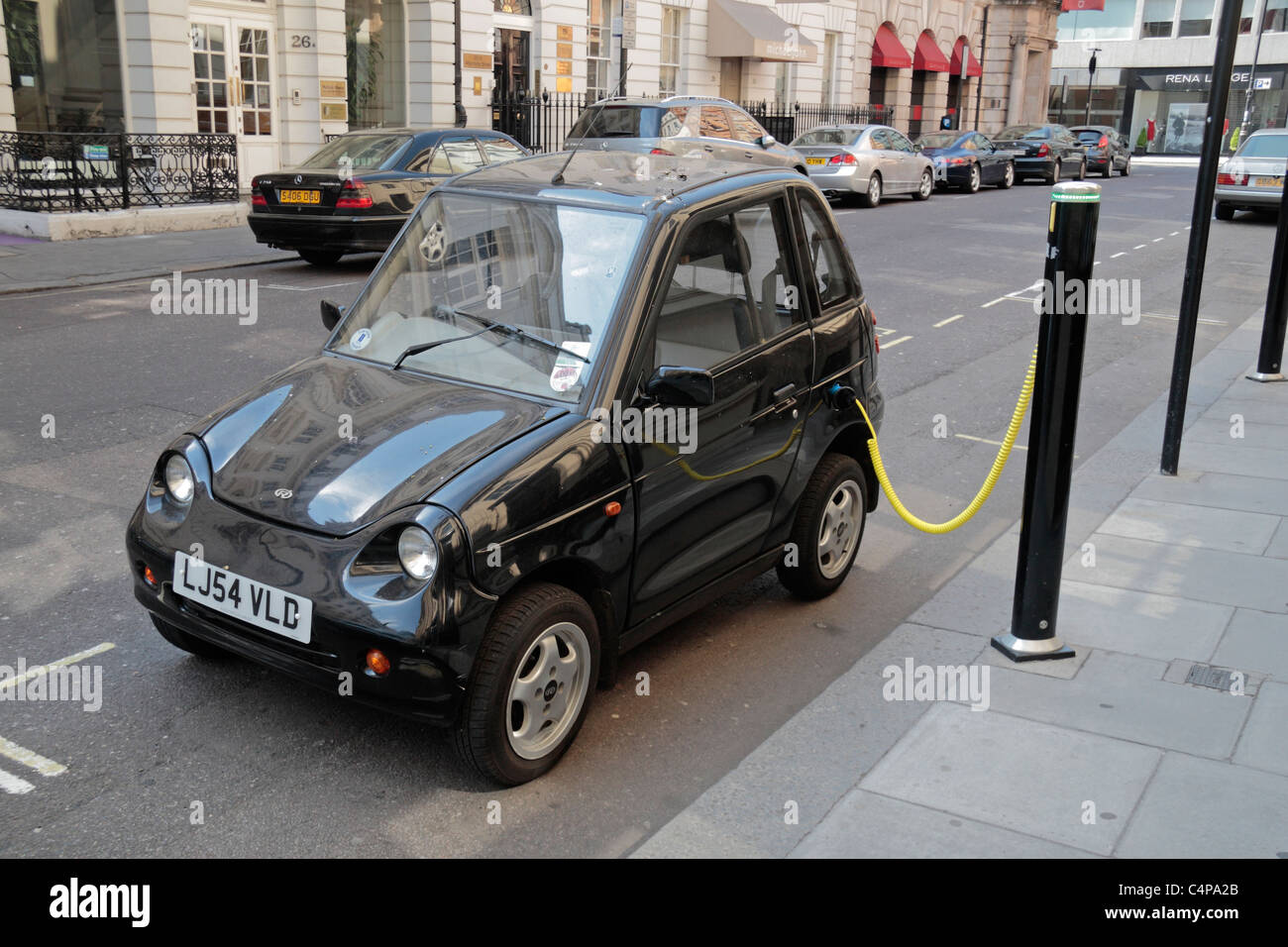 An electric G Wiz car being charged at a Elektrobay on-street recharging point on Albemarle Street, London.  Apr 2011 Stock Photo
