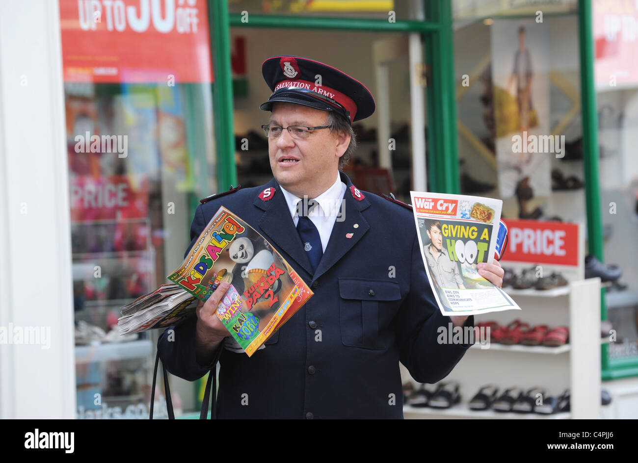 Salvation Army soldier selling War Cry magazine Weston-super-Mare Somerset England Uk Stock Photo