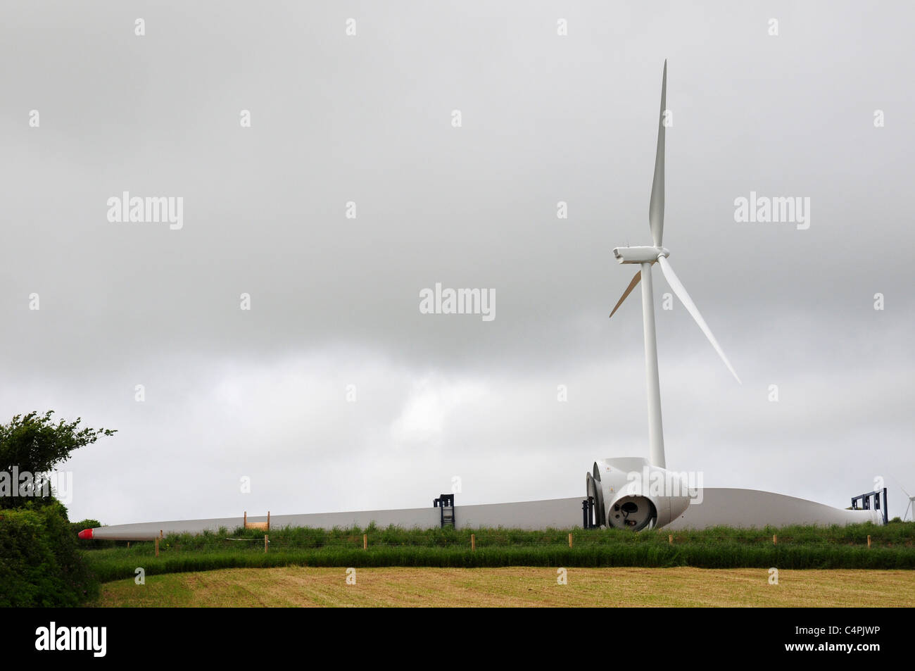 Huge wind turbine erected and blade (45m) and nose cone on ground. Fullabrook Wind Farm, North Devon. Stock Photo