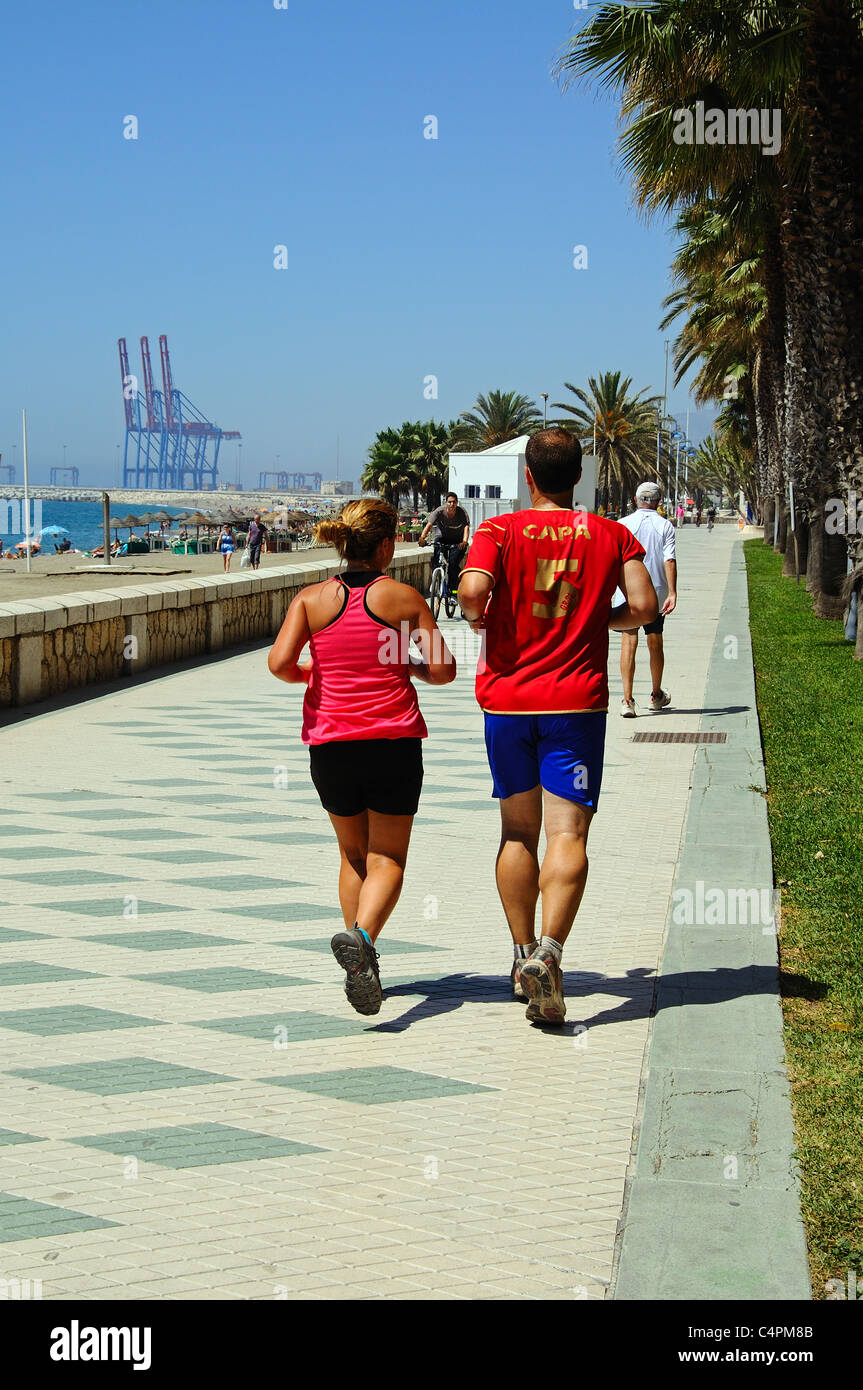 Joggers on the promenade alongside Malagueta beach, Malaga, Costa del Sol, Malaga Province, Andalucia, Spain, Western Europe. Stock Photo