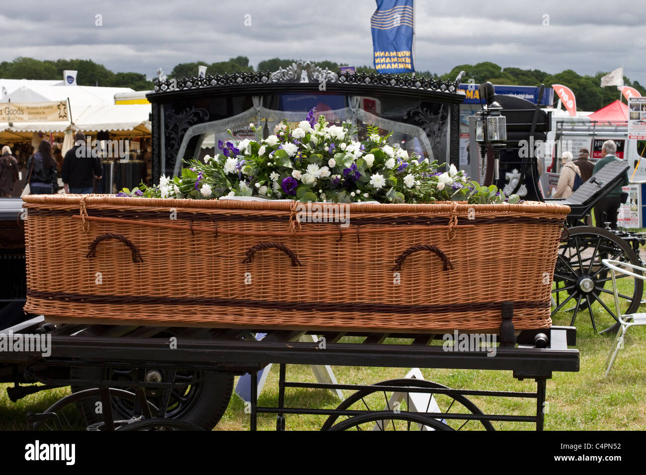 Funeral Directors, wicker, wickerwork, plaited or woven twigs or osiers casket, case, casket, cemetery, closed coffin, dead, death, eco, ecological, eternity, ethical, funeral, grave, green burial. Stands & Exhibits at the Cheshire Game & Country Fair Show, Knutsford, UK Stock Photo