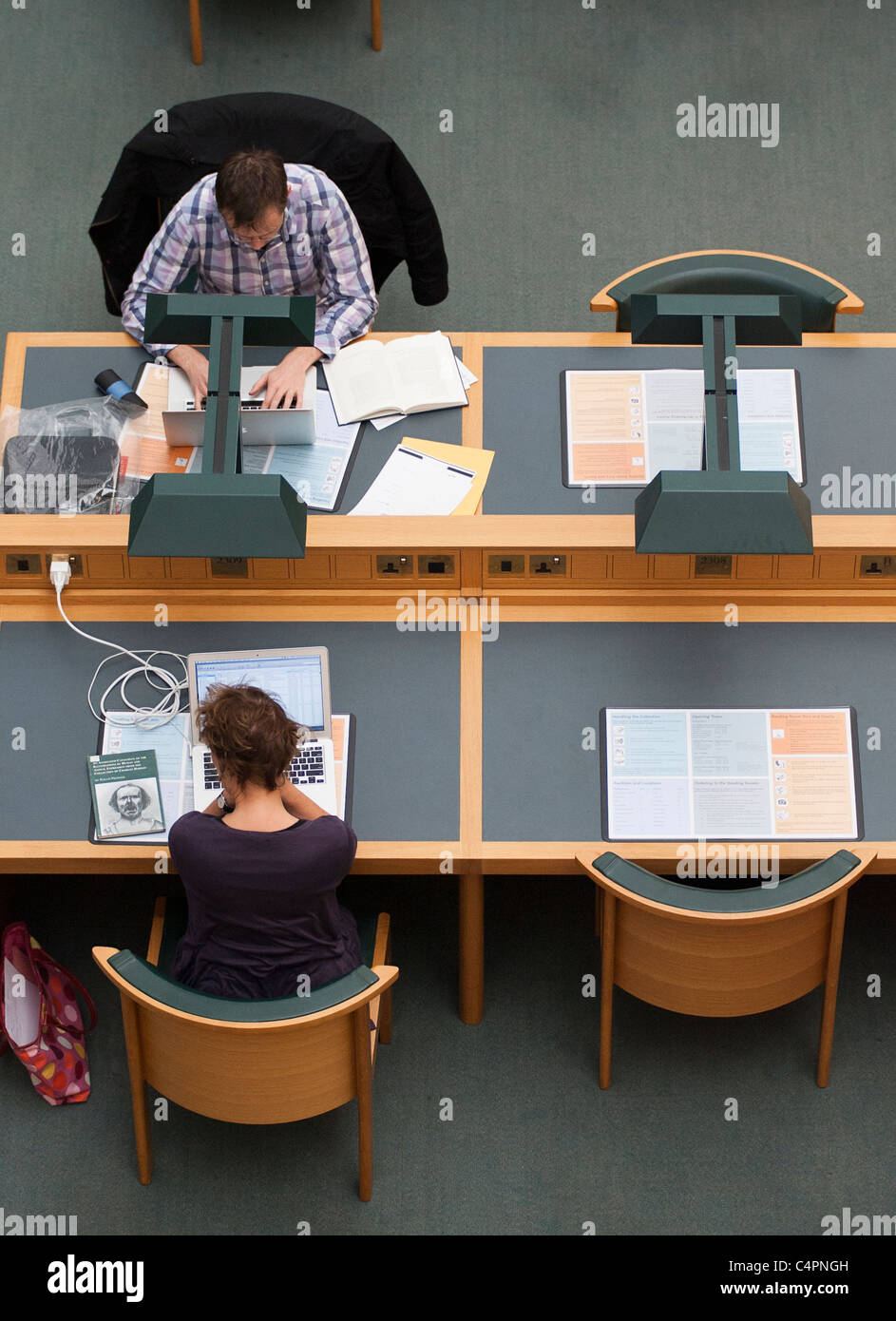Visitors to the British Library sit and read at tables. Stock Photo
