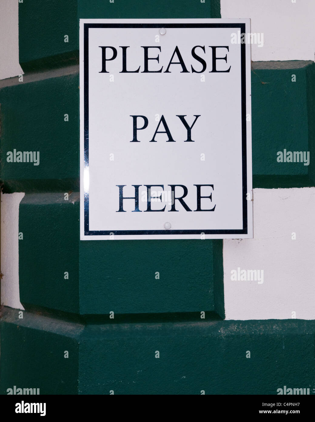 Please pay here sign Stock Photo