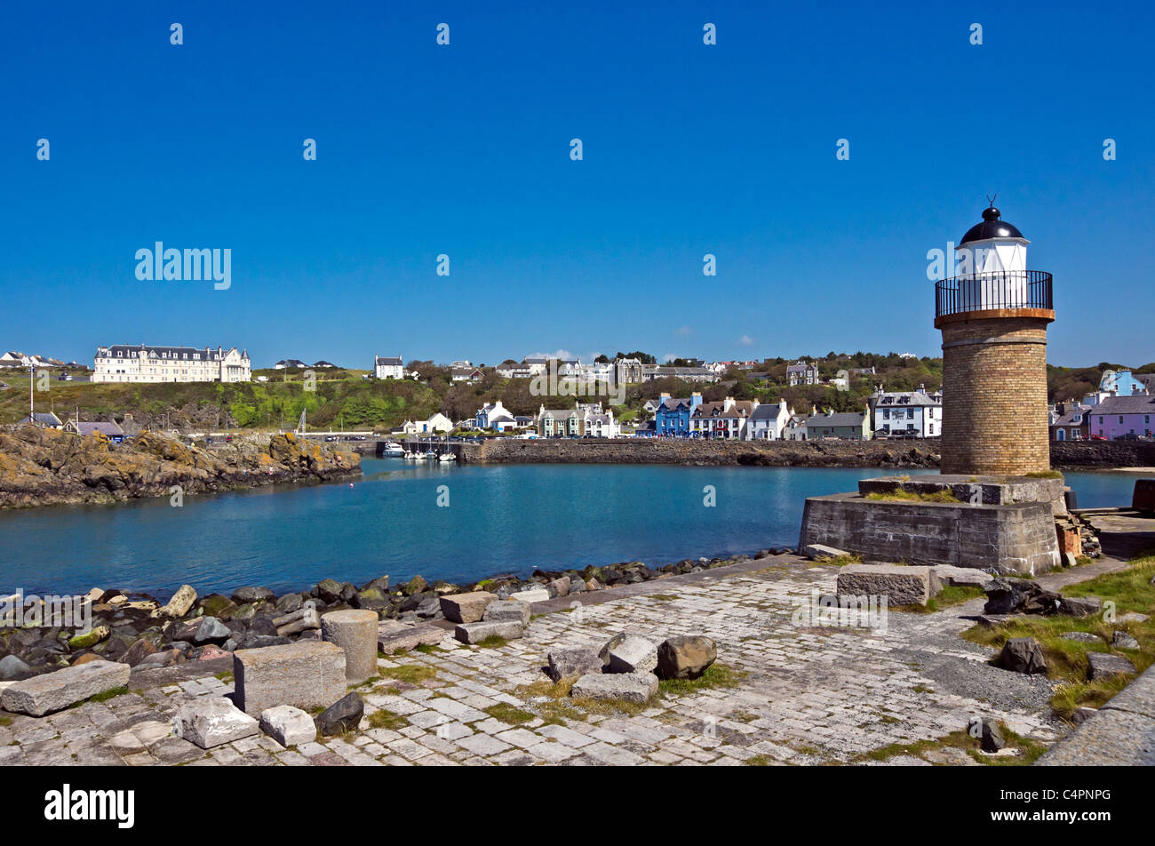 Portpatrick harbour in Dumfries & Galloway Scotland with the old lighthouse at the entrance and Portpatrick Hotel left Stock Photo