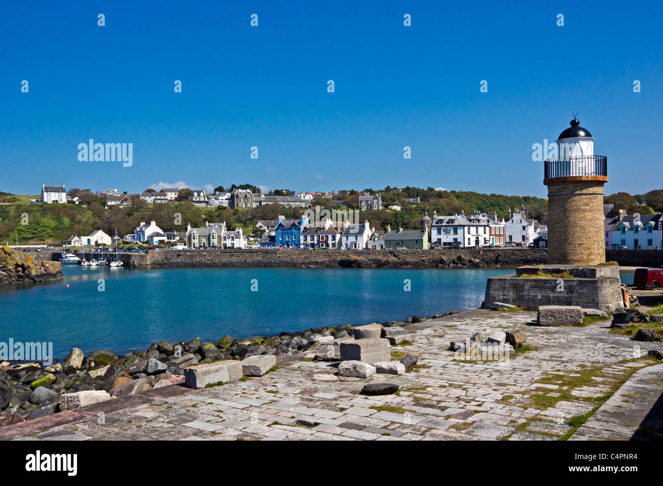 Portpatrick harbour in Dumfries & Galloway Scotland with the old lighthouse at the entrance. Stock Photo