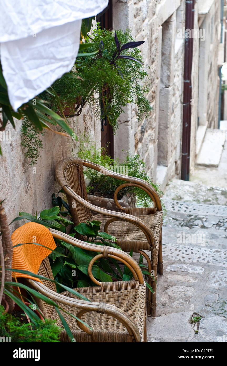 Two wicker chairs in front of a house, Dubrovnik, Croatia Stock Photo