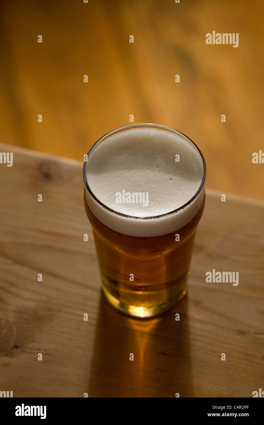 pint of british beer on pub table Stock Photo
