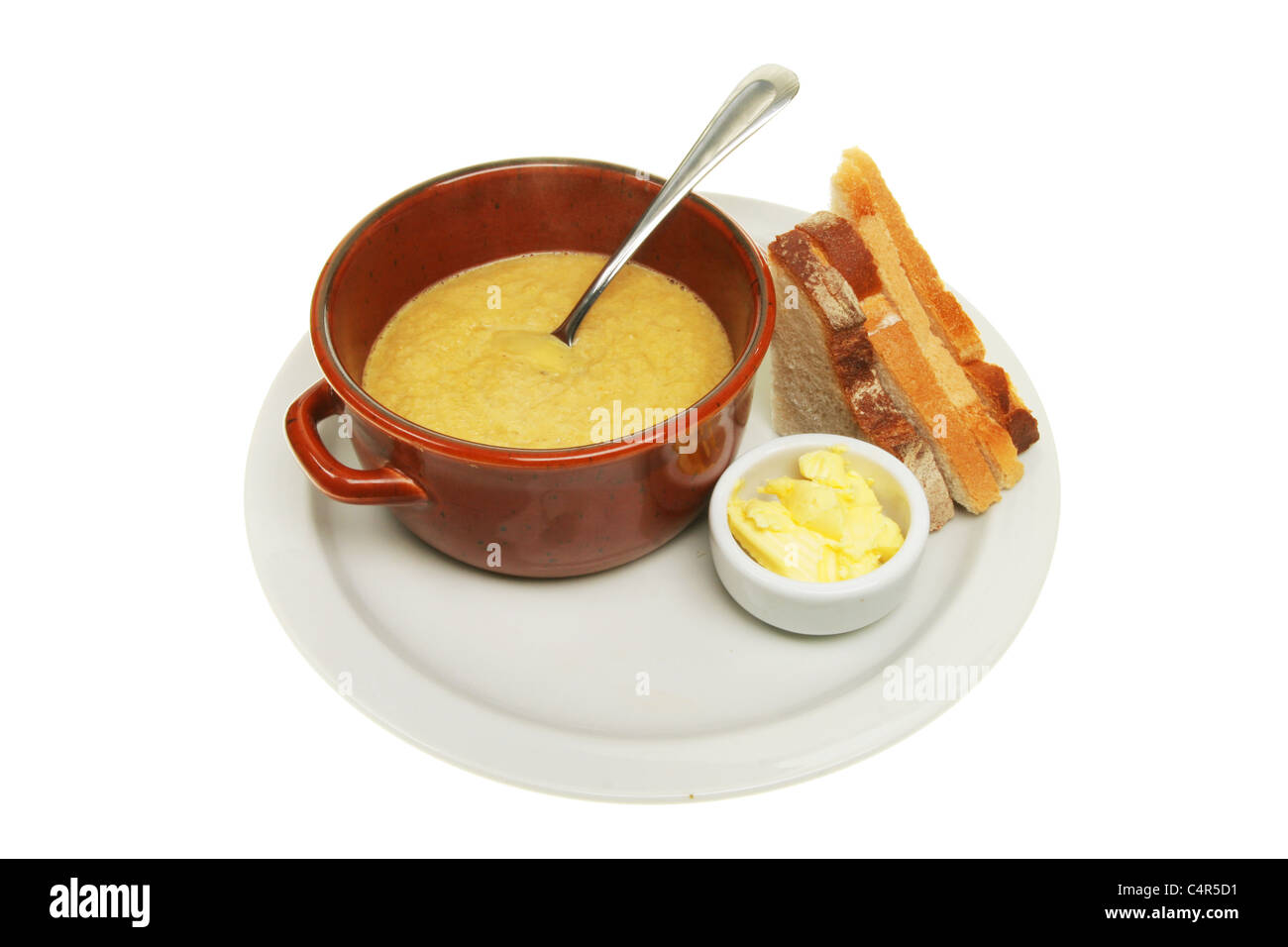 Soup with bread and butter on a white plate Stock Photo