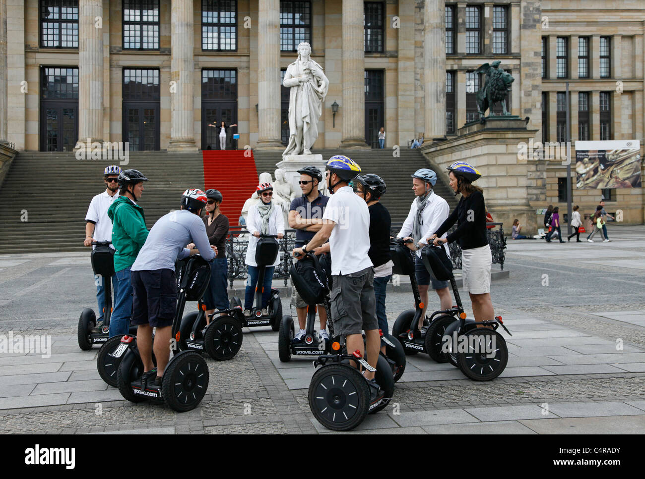 A group of tourists on a Segway two-wheeled, self-balancing personal transporter tour the city in Berlin Germany Stock Photo
