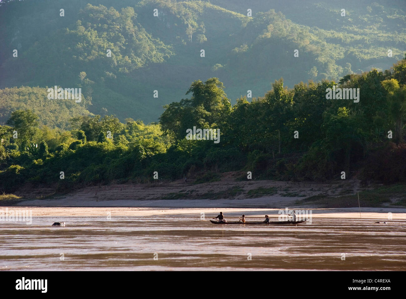 Boating on the Mekong River in a longboat, Laos Stock Photo