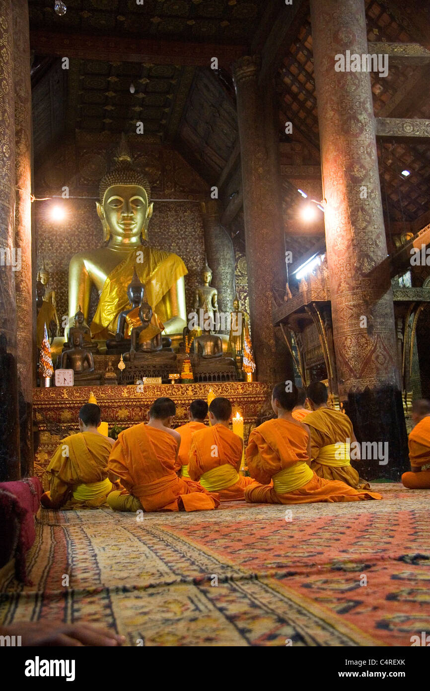Monks in temple, Luang Prabang, Laos Stock Photo