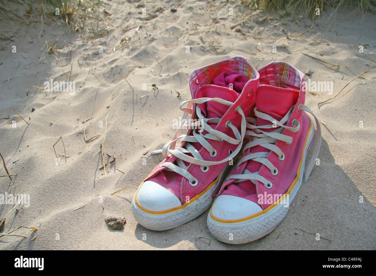 Pink sneakers on beach, Guinard Beach, Scotland Stock Photo