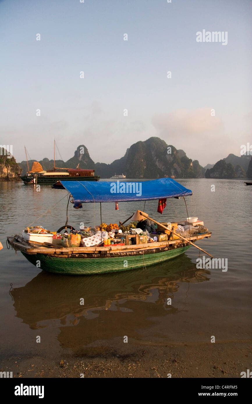 Vietnamese boat vendor on Ha Long Bay, Vietnam Stock Photo