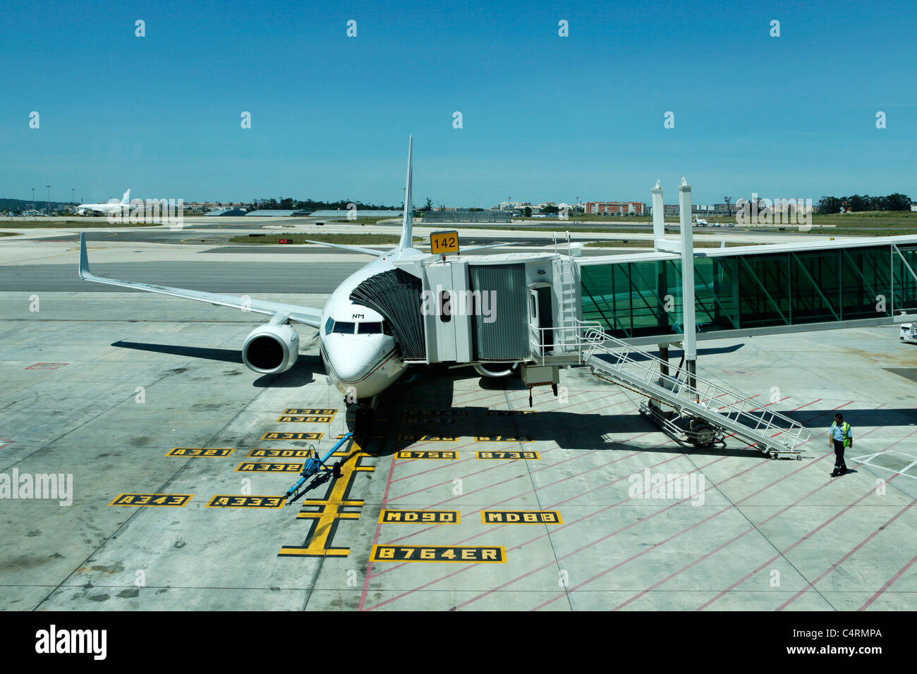An passenger airliner is docked to the terminal at Lisbon International