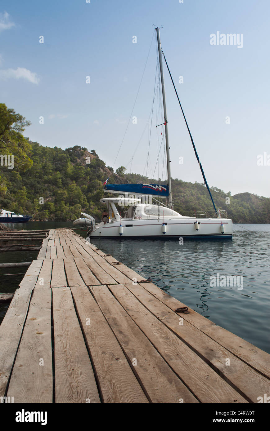 Charter boat on a wooden jetty at Tomb Bay, a cove on the Lycian coast near Gocek  Turkey Stock Photo