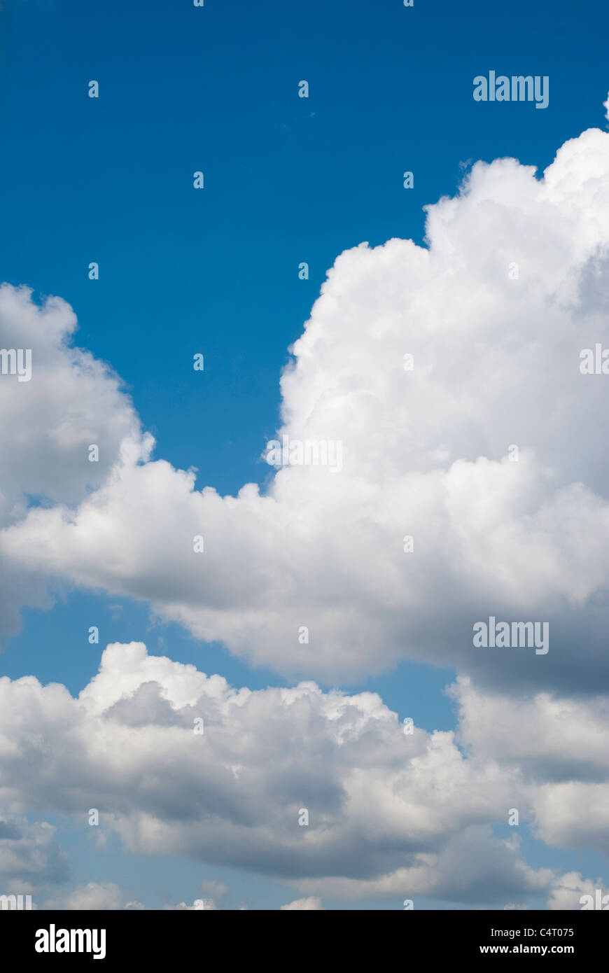 Fluffy clouds on blue sky Stock Photo - Alamy
