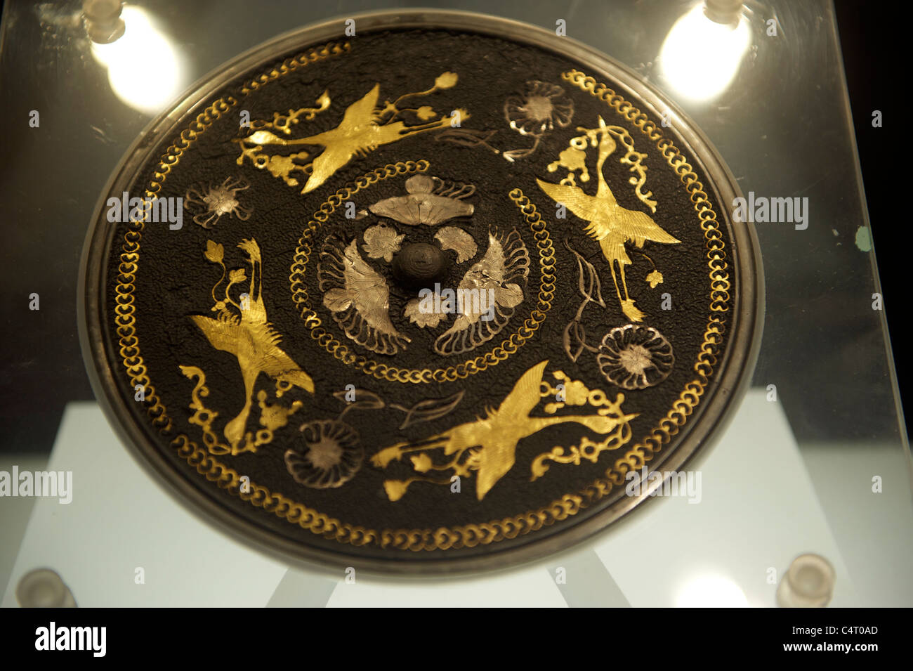 Mirror with Lacquered Back Inlaid with Four Phoenixes Holding Ribbons in Their Mouths, Tang Dynasty. Stock Photo
