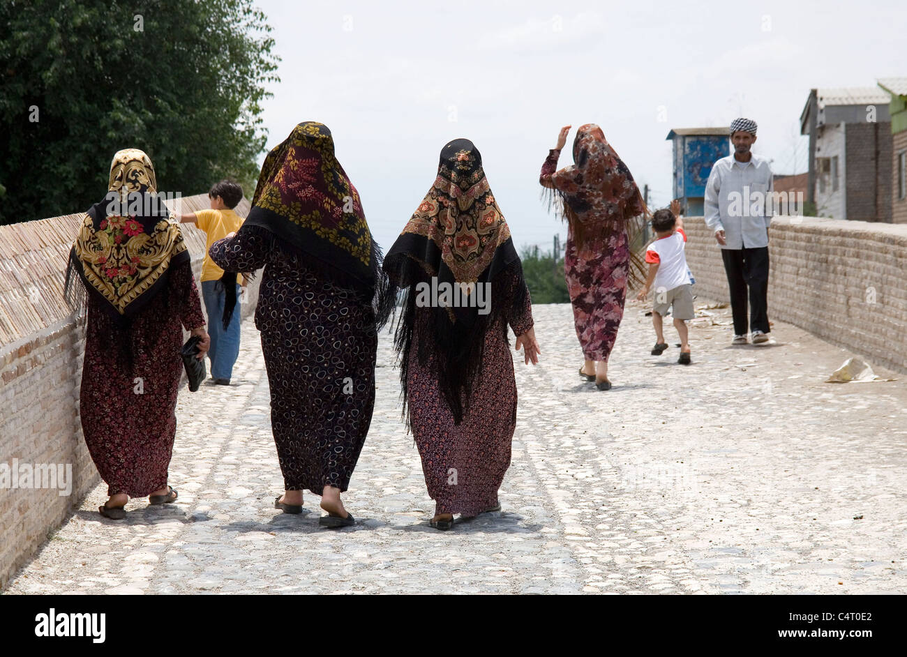 Iranian women, children and man walking on a bridge (Pol-e Safavi) in Aq Qal'eh (or Aq Qala), Iran. Daily life in the Middle East Stock Photo