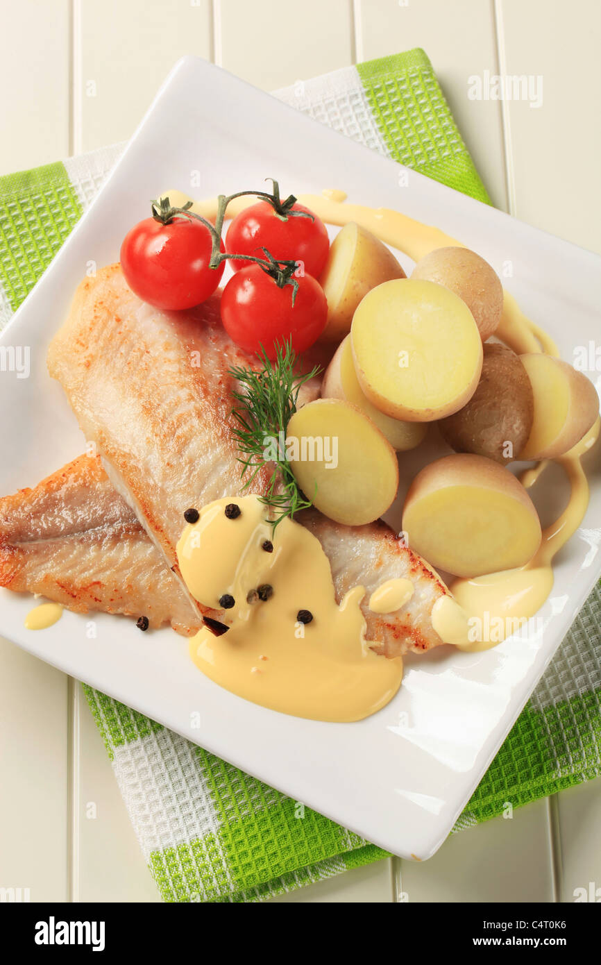 Pan fried fish fillets with potatoes and Hollandaise sauce Stock Photo