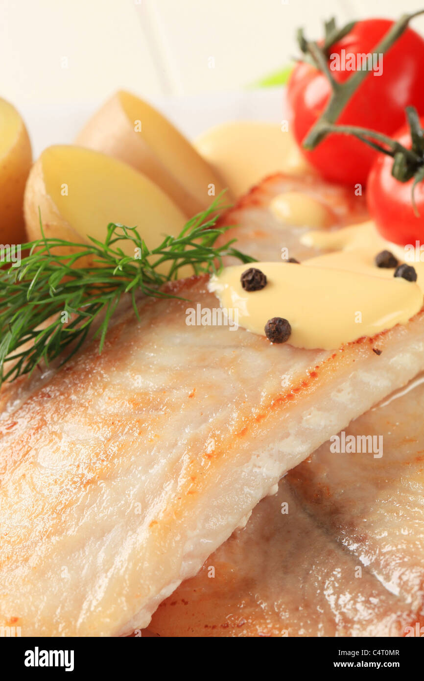 Pan fried fish fillets with potatoes and Hollandaise sauce Stock Photo