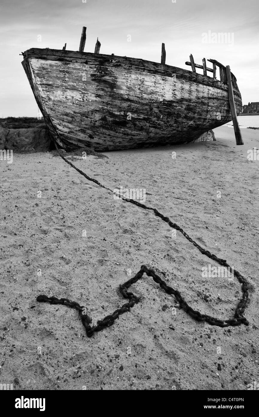 A wrecked boat on a beach Stock Photo