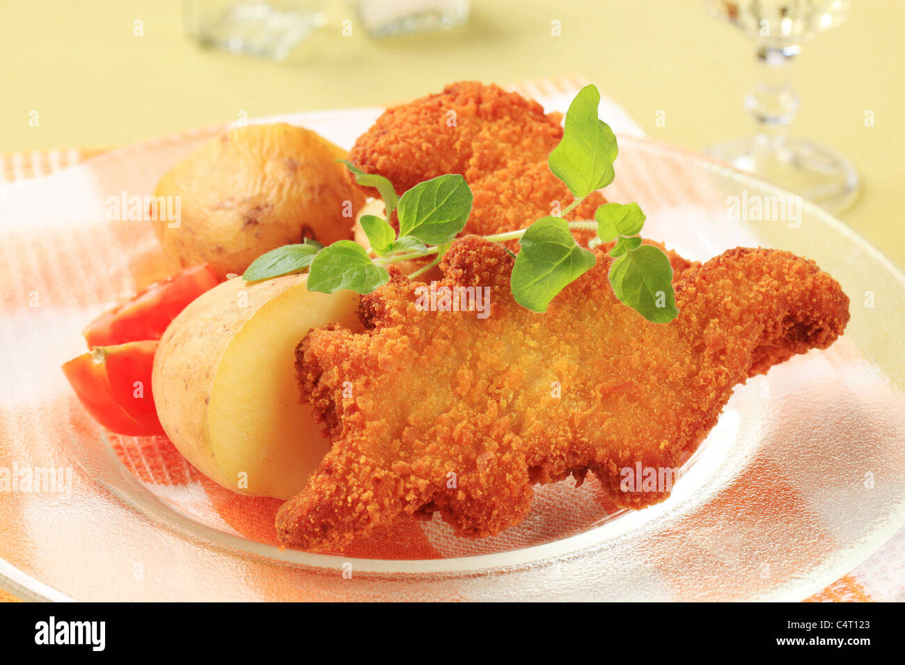 Dinosaurs shaped fried fish and potatoes - closeup Stock Photo