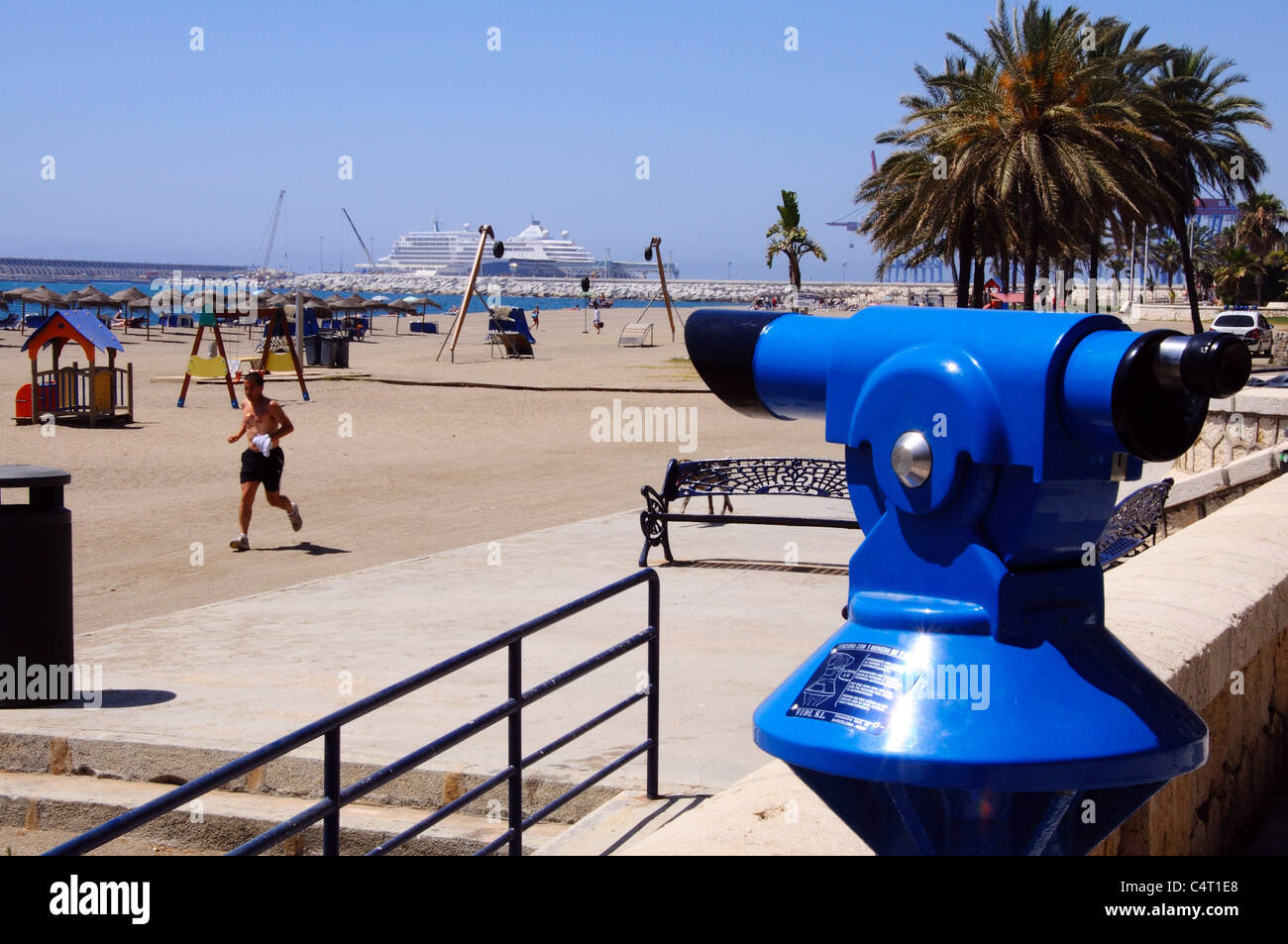 Telescope on the edge of Malagueta beach looking towards the port and Mediterranean sea, Malaga, Costa del Sol, Spain. Stock Photo