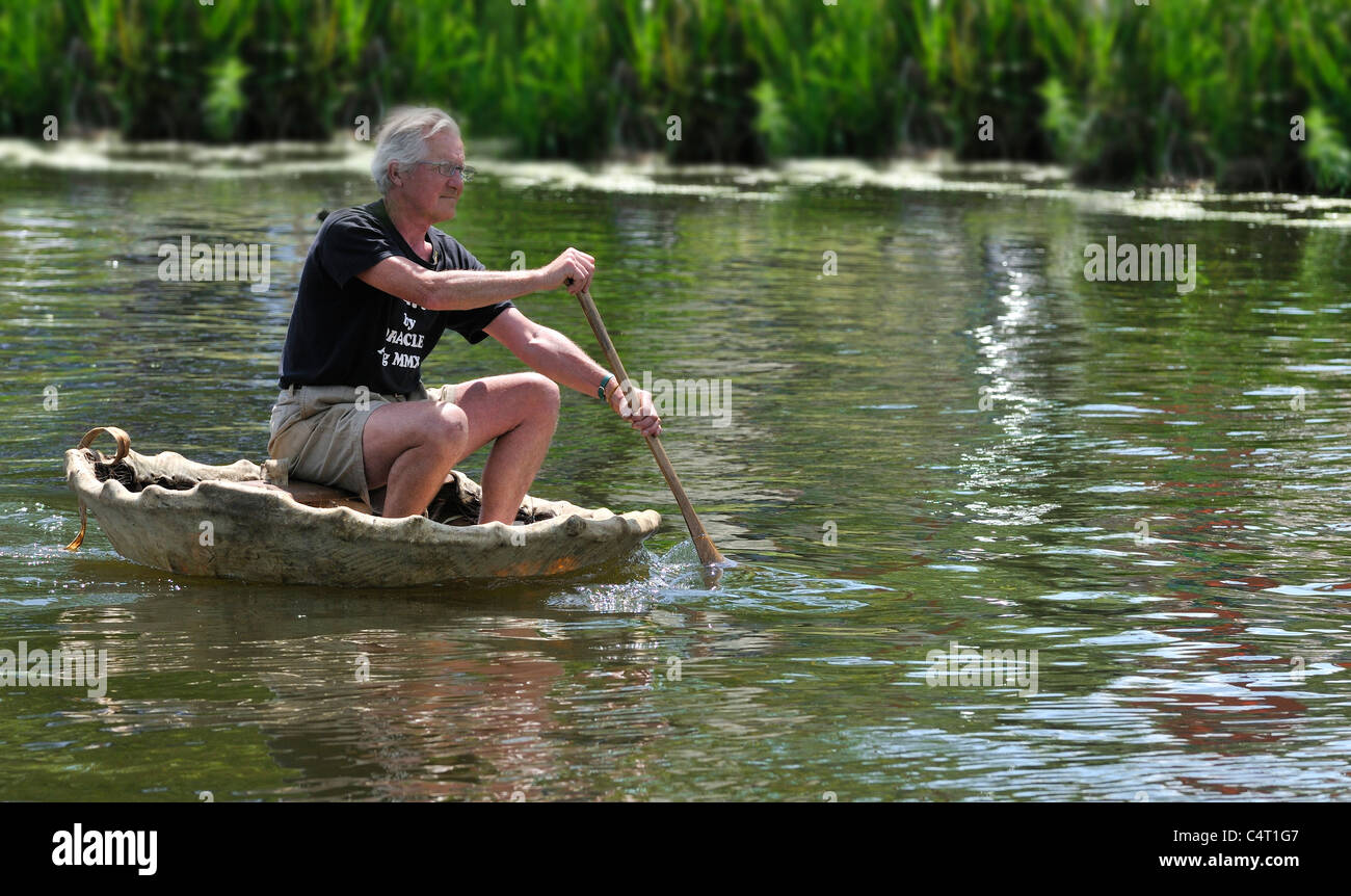 Peter Faulkner  the “The Oracle of Coracles'  paddles his coracle at the Beale Park Boat Show 2011, Pangbourne, Berkshire, England, UK Stock Photo