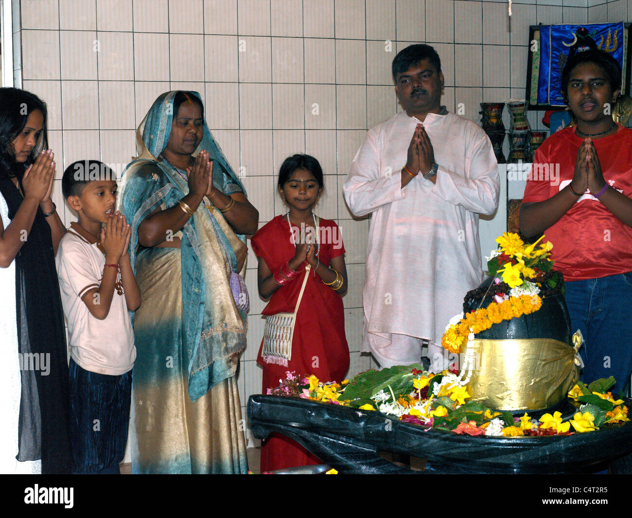 Grand Bassin Mauritius Family Praying infront of Shiva Lingum Stock Photo
