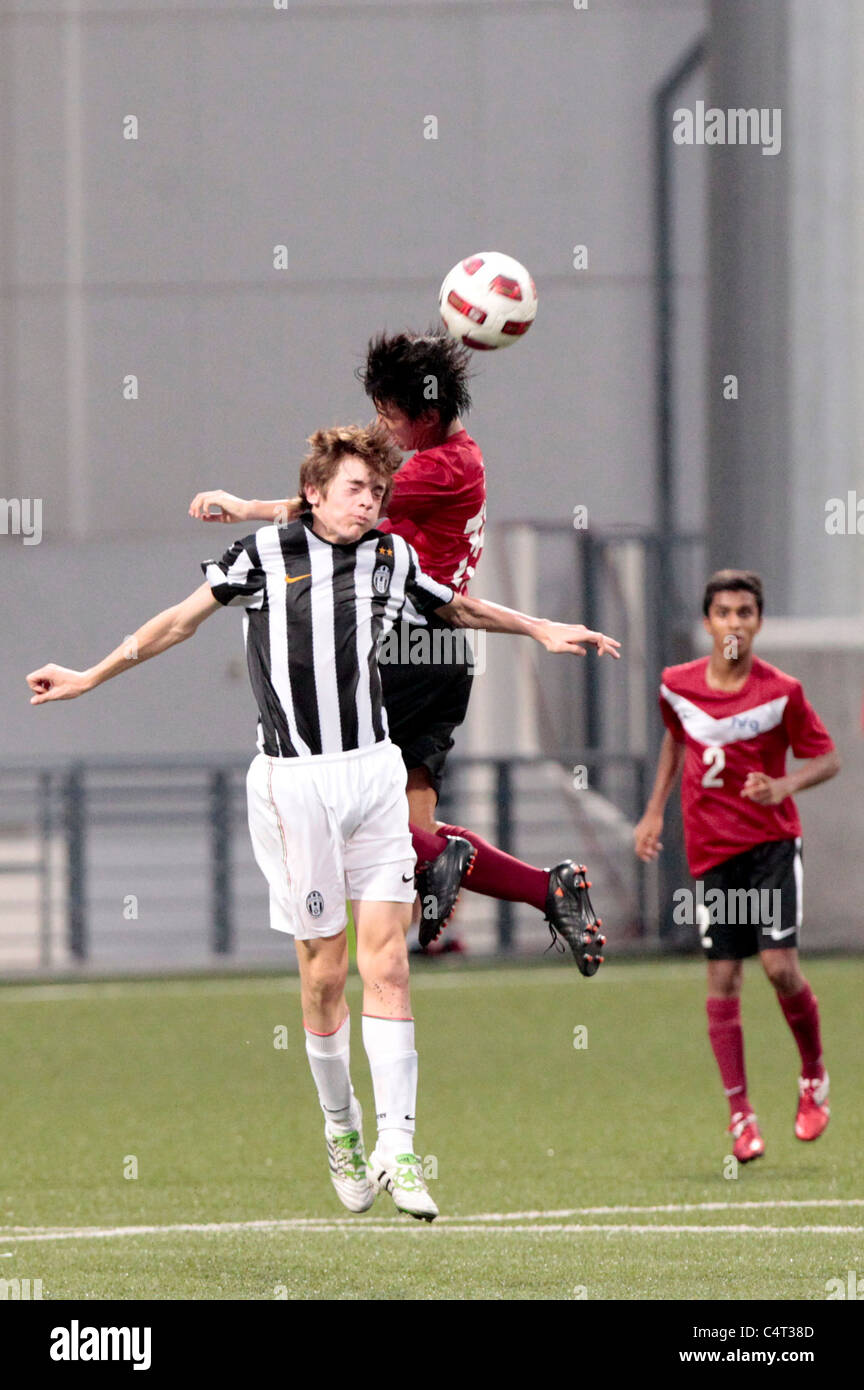 Raja Ahmad Zaki Of Singapore U15 Red And Giannarelli Andrea Battle For The Aerial Ball During The 23rd Canon Lion City Cup Stock Photo Alamy