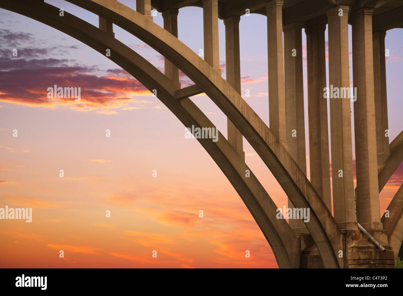 Highway Bridge, Arch And Structural Supports Against A Red Evening Sky, The Little Miami River, Ohio, USA Stock Photo