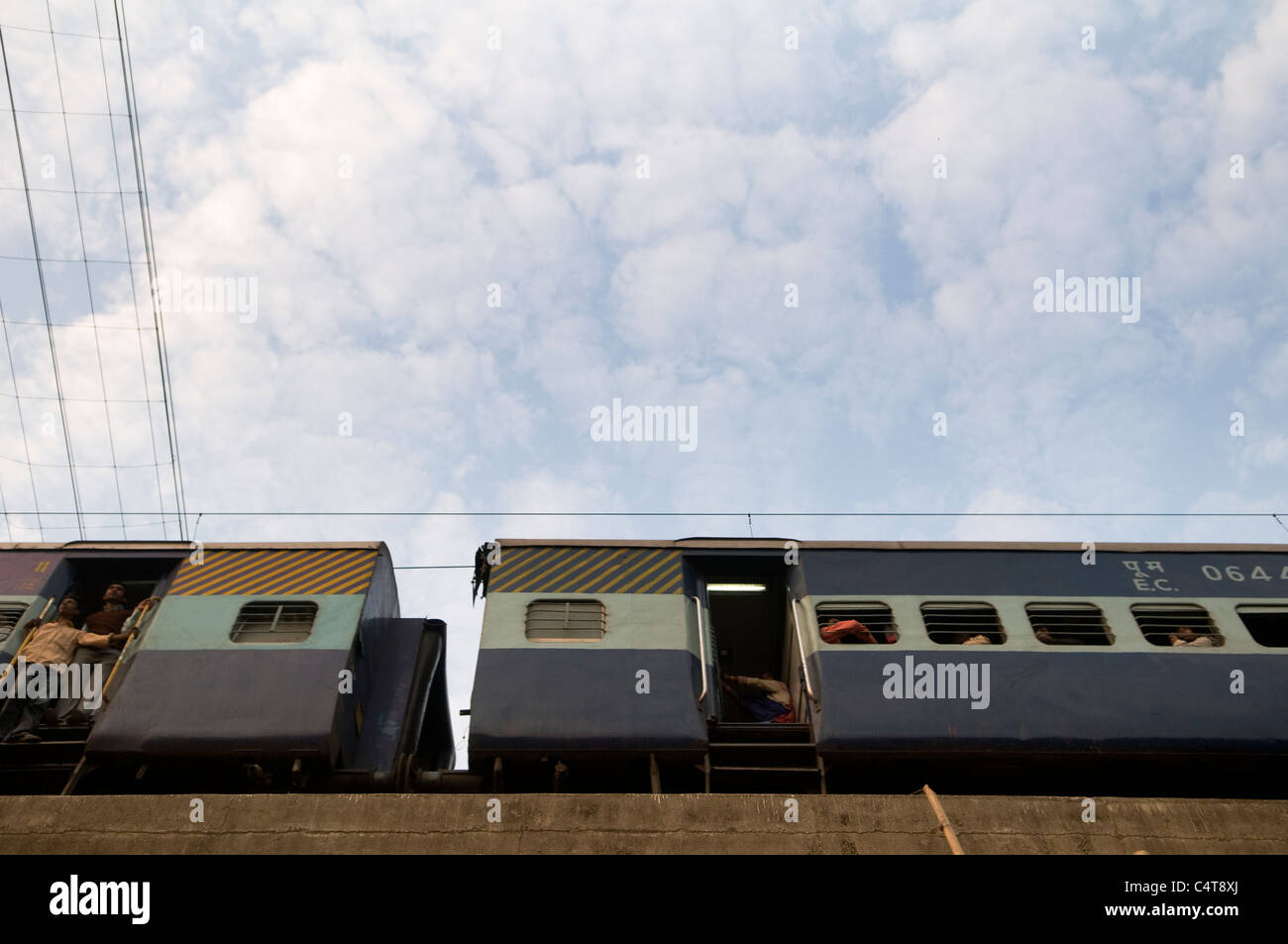 A local Indian train corssing a small bridge in Bihar, India. Stock Photo