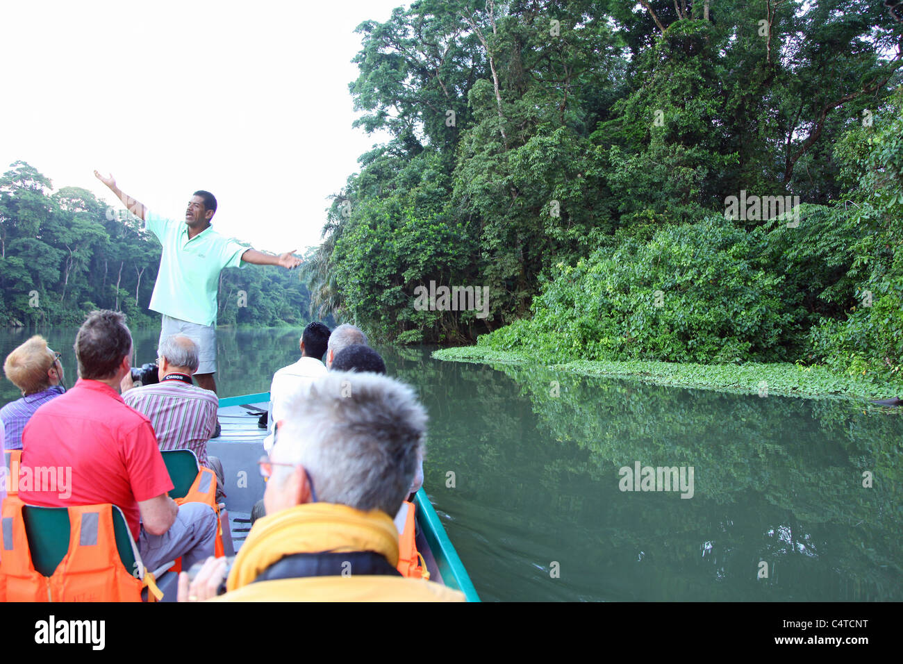 A guide and tourists on a boat on the canals at Tortuguero National Park Costa Rica Central America Stock Photo