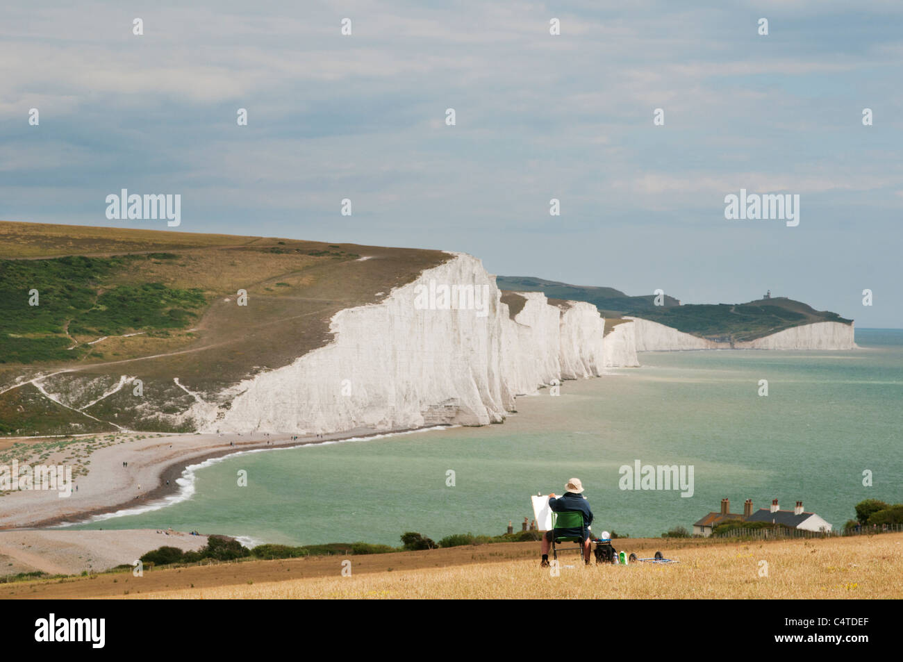 Artist with easel painting the Seven Sisters, Seaford, South Downs National Park, East Sussex, England, July. Stock Photo