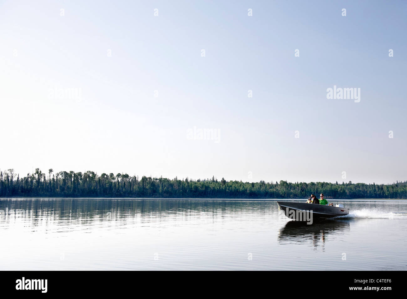 Family Boating, Otter Lake, Missinipe, Saskatchewan, Canada Stock Photo