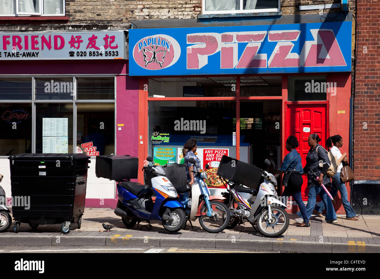 Scene outside a pizza take away shop in Stratford in East London, UK. Stock Photo