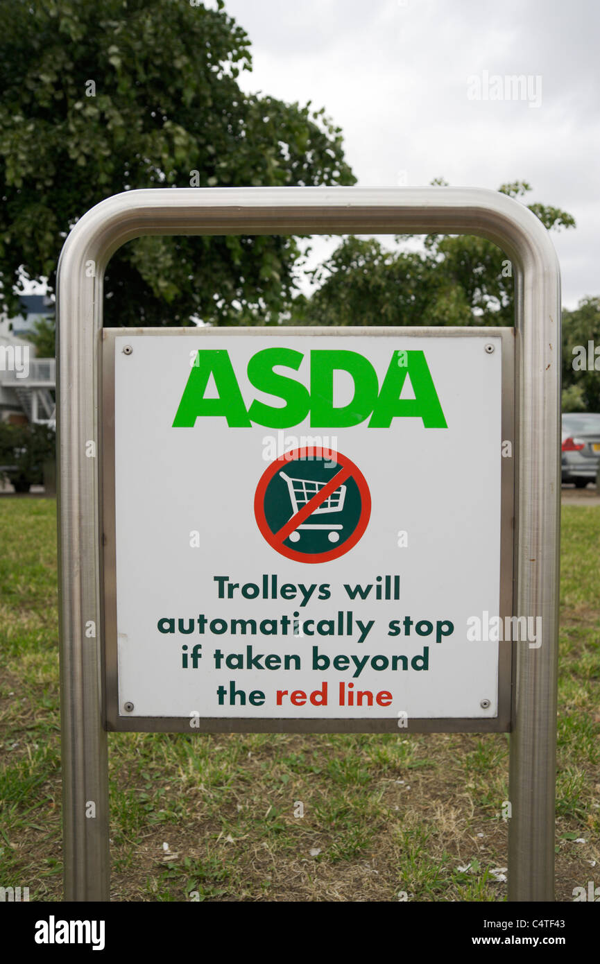 ASDA shopping centre near Crossharbour, Isle of Dogs, London, UK. Sign about trolley anti theft feature. Stock Photo
