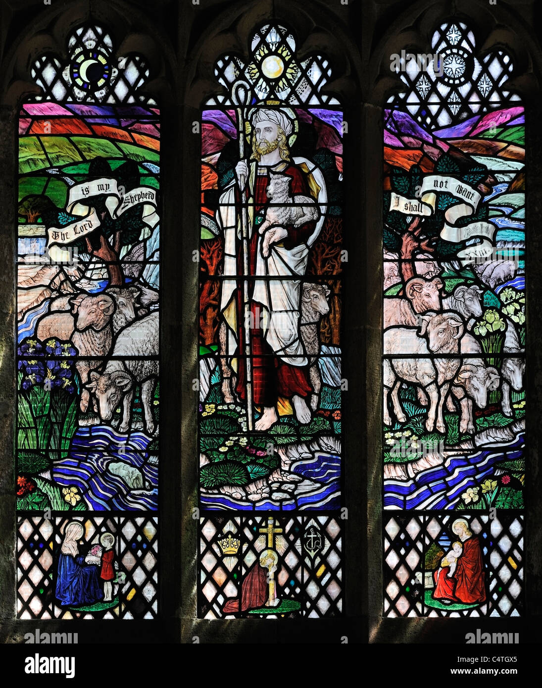 Colourful stained glass window depicting Christ the Shepherd, Muker Church, Swaledale, Yorkshire, England Stock Photo