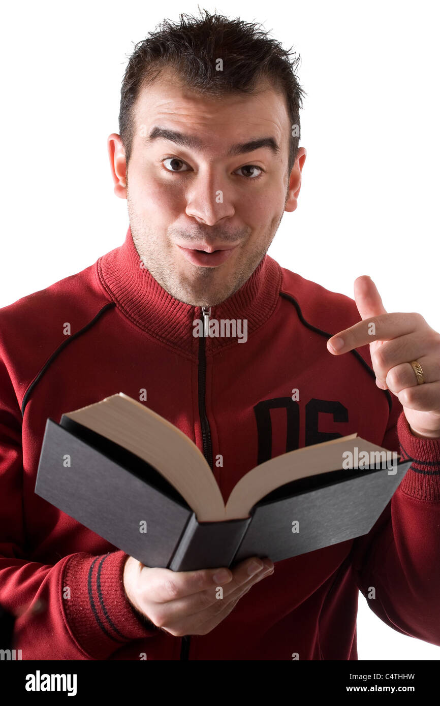 A young man reading a book with a surprised expression on his face