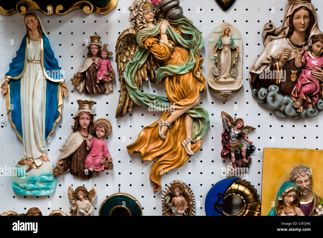 Catholic devotional objects for sale in a religious shop in Bogota, Colombia. Stock Photo