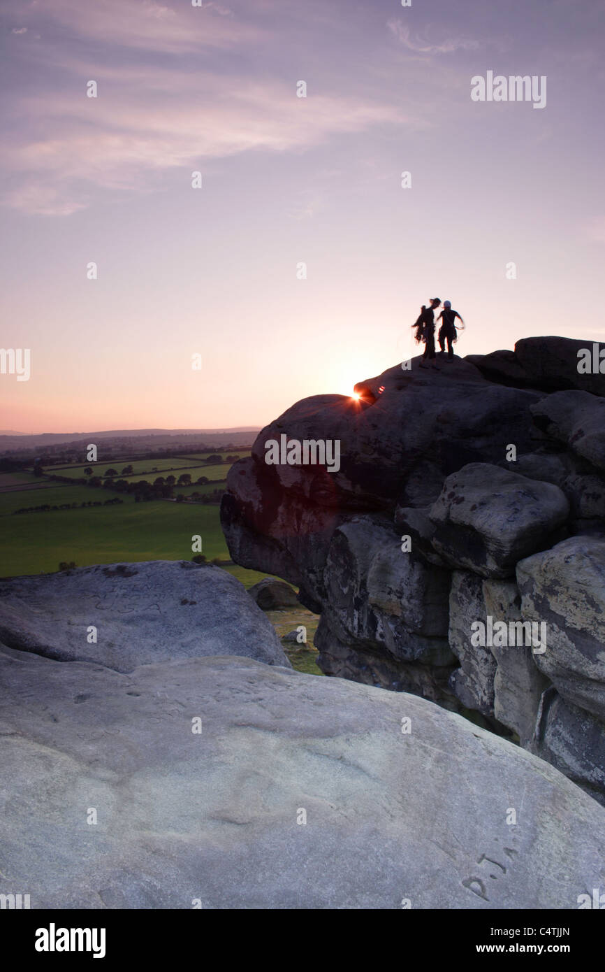 Climbers on top of Almscliff Crag, North Rigton, North Yorkshire, England, UK, Summer Stock Photo