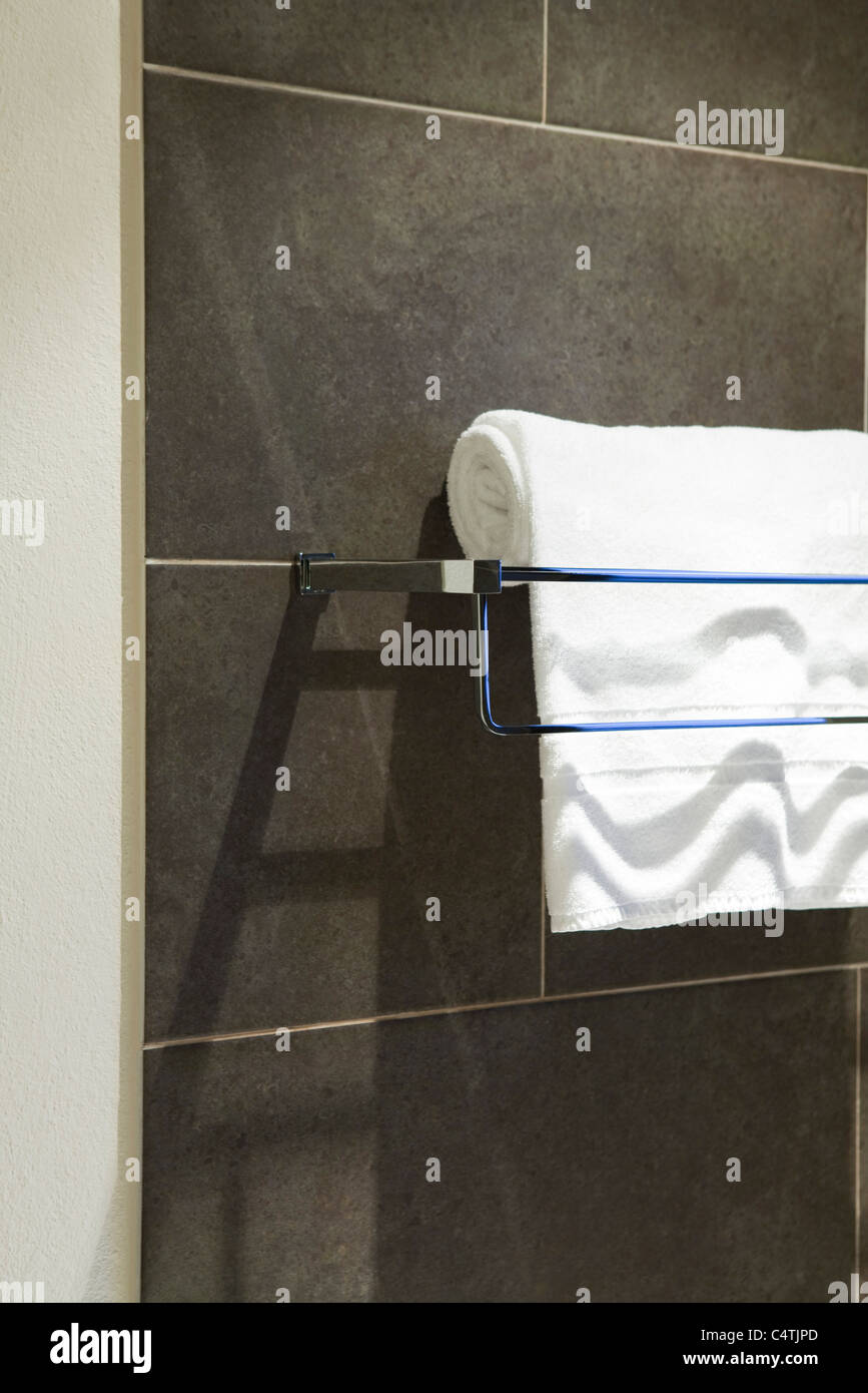 Bath towel folded over towel rack Stock Photo - Alamy